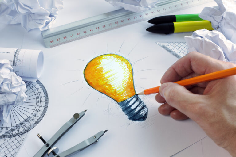 Designer,Drawing,A,Light,Bulb,,Concept,For,Brainstorming,And,Inspiration