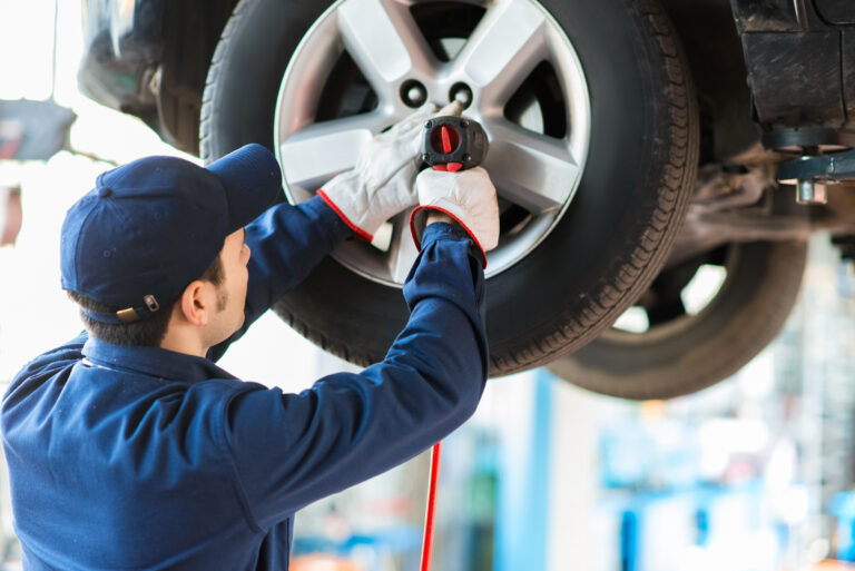 Mechanician,Changing,Car,Wheel,In,Auto,Repair,Shop