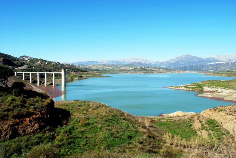 View,Of,Lake,Vinuela,With,Snow,Capped,Mountains,To,The