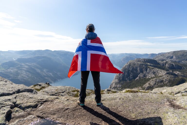 Woman,With,A,Waving,Flag,Of,Norway,On,The,Background